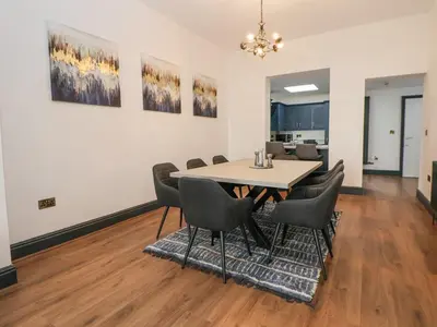a dining room with a table and chairs at The Alhambra in Southport