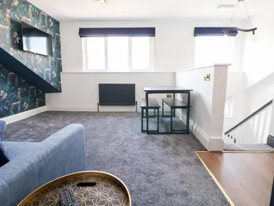 a living room with a couch and a table at The Alhambra in Southport