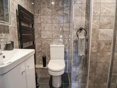 a bathroom with a toilet and a sink at The Alhambra in Southport