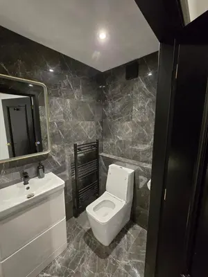 a bathroom with a toilet and a sink and a mirror at 3M Luxury Living in Preston