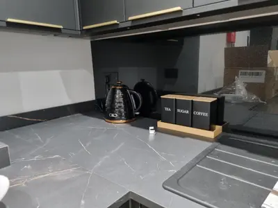 a kitchen counter with a tea kettle and boxes on it at 3M Luxury Living in Preston