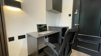 a room with a desk with a laptop on it at 3M Luxury Living in Preston