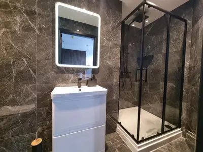 a bathroom with a shower and a sink and a mirror at 3M Luxury Living in Preston