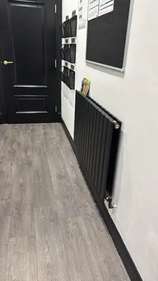 a hallway with black doors and a wooden floor at 3M Luxury Living in Preston