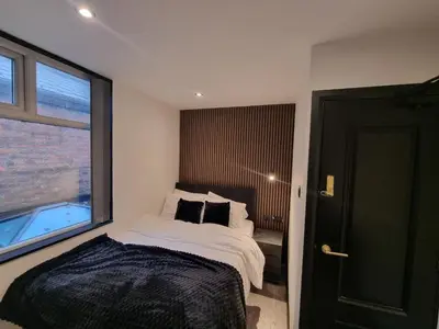 a bedroom with a bed and a large window at 3M Luxury Living in Preston