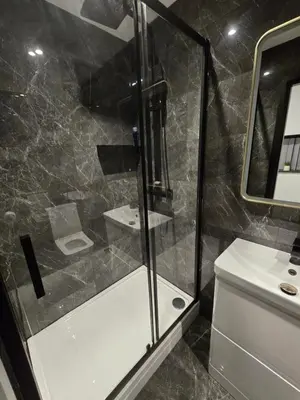a bathroom with a shower and a toilet and a sink at 3M Luxury Living in Preston