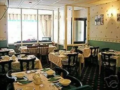 a restaurant with tables and chairs in a room at Roselea Hotel - St Chads in Blackpool