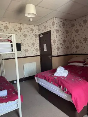 a bedroom with a bunk bed and a ladder at Roselea Hotel - St Chads in Blackpool