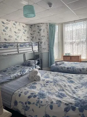 a bedroom with two bunk beds and a window at Roselea Hotel - St Chads in Blackpool
