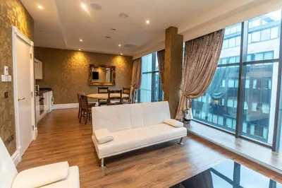 a living room with a white couch and a table at The Shankly Hotel in Liverpool
