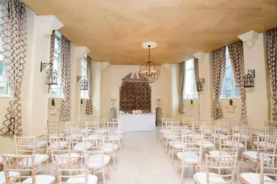 a room with white chairs and a table in a building at The Shankly Hotel in Liverpool
