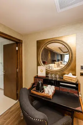a room with a vanity with a mirror and a chair at The Shankly Hotel in Liverpool