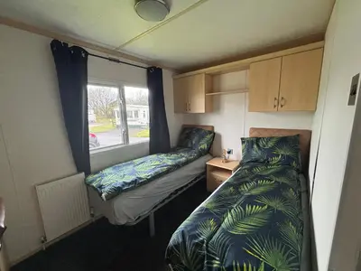 a small room with a bed and a window at 148 Port Haverigg in Millom