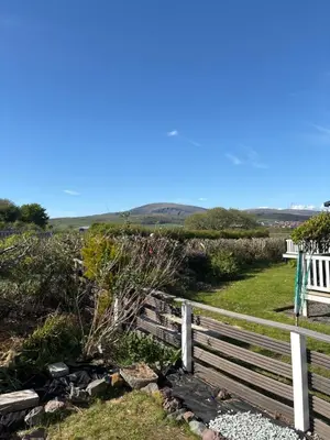 a wooden fence and a bench on a hill at 148 Port Haverigg in Millom