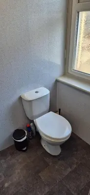 a white toilet in a bathroom with a window at Apartment 5 in Blackpool
