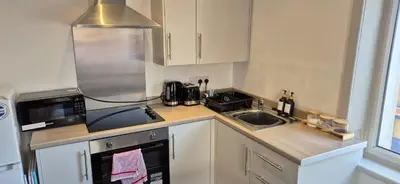 a small kitchen with a sink and a microwave at Apartment 5 in Blackpool