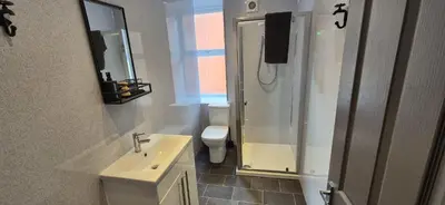 a bathroom with a sink and a toilet and a mirror at Apartment 5 in Blackpool