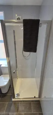 a shower stall in a bathroom with a toilet at Apartment 5 in Blackpool