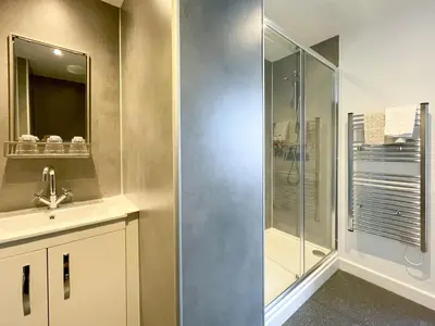 a bathroom with a shower and a sink at The Auckland Hotel in Morecambe