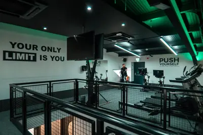 a man standing in a room with a gym at Riverside Holiday Park in Banks