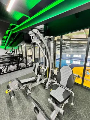 a gym with two chairs and a treadmill at Riverside Holiday Park in Banks