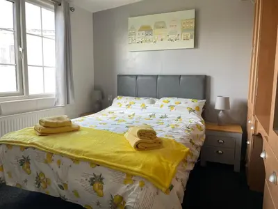 a bedroom with a bed with two towels on it at The Dean's on the Lune in Heysham