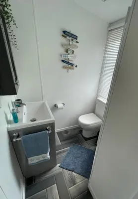 a small bathroom with a sink and a toilet at The Dean's on the Lune in Heysham