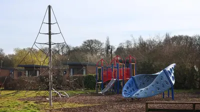 a playground in a park with a slide at Royal Umpire Caravan Park in Croston