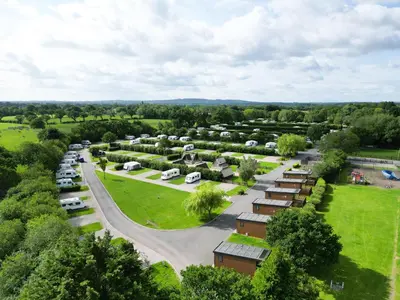 an aerial view of a parking lot with parked cars at Royal Umpire Caravan Park in Croston