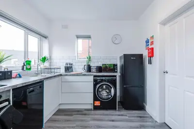 a kitchen with a washing machine and a refrigerator at Acacia Lodge Retreat - Beautiful & Modern 3-BR with Wi-Fi by Parydise Properties in Shevington