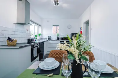 a kitchen and dining room with a table and chairs at Acacia Lodge Retreat - Beautiful & Modern 3-BR with Wi-Fi by Parydise Properties in Shevington