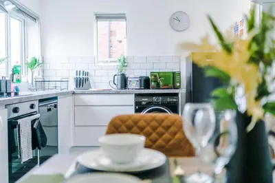 a kitchen with a table with a chair in it at Acacia Lodge Retreat - Beautiful & Modern 3-BR with Wi-Fi by Parydise Properties in Shevington