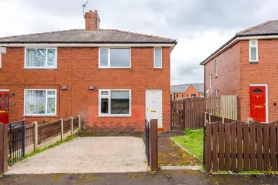 a brick house with a wooden fence in front of it at Acacia Lodge Retreat - Beautiful & Modern 3-BR with Wi-Fi by Parydise Properties in Shevington