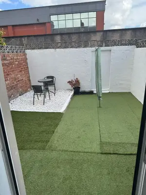 a patio with a table and chairs on a lawn at Comfort, Convenience & Style in Preston