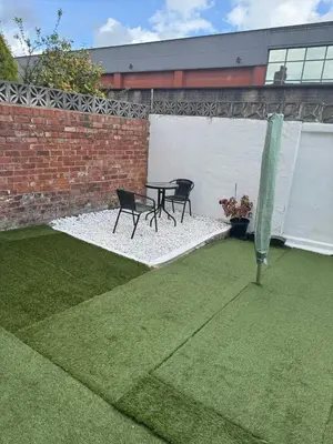 a patio with two chairs and a table in a yard at Comfort, Convenience & Style in Preston