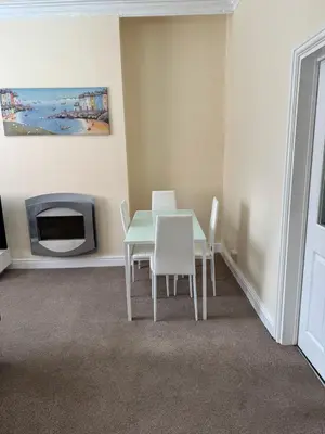 a dining room with a table and a tv at Comfort, Convenience & Style in Preston