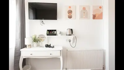 a white table with a tv on a wall at Entire Manor Grove Blackpool in Blackpool
