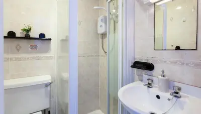 a bathroom with a toilet and a sink and a mirror at Entire Manor Grove Blackpool in Blackpool