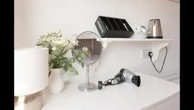 a white counter with a sink and flowers on it at Entire Manor Grove Blackpool in Blackpool