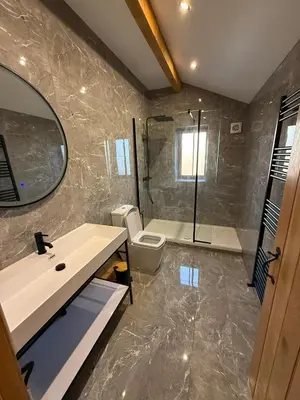 a bathroom with a sink and a toilet and a mirror at Ribble Valley Hideaways in Preston