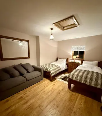 a living room with a couch and a bed at Ribble Valley Hideaways in Preston