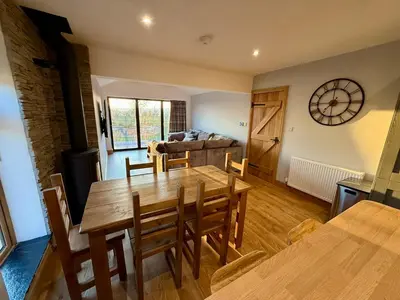 a dining room with a table and a couch at Ribble Valley Hideaways in Preston