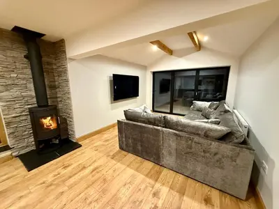 a living room with a couch and a fireplace at Ribble Valley Hideaways in Preston