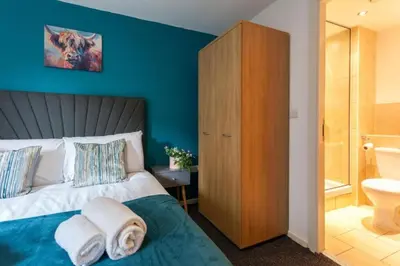 a bedroom with a bed with towels on it at Elegant City Retreat Contemporary 2BR 2BA Netflix Included in Liverpool