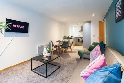 a living room with a couch and a table at Prime City Centre Living Large 2 Bed 2 Bath Free Netflix Sleeps 7 in Liverpool