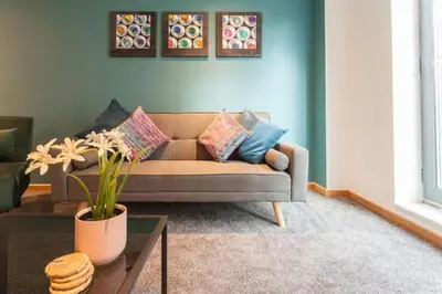 a living room with a couch and a table at Prime City Centre Living Large 2 Bed 2 Bath Free Netflix Sleeps 7 in Liverpool