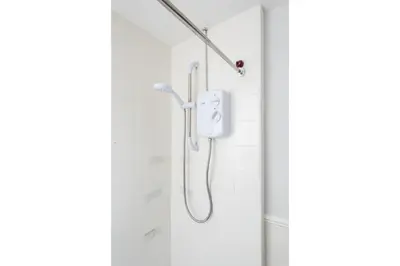 a shower with a shower head in a bathroom at Anfield Escape in Liverpool