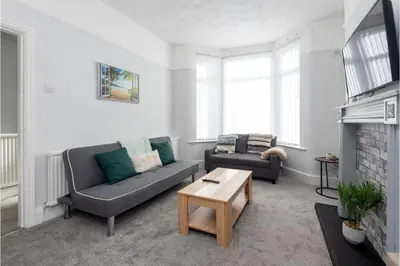 a living room with two couches and a coffee table at Anfield Escape in Liverpool