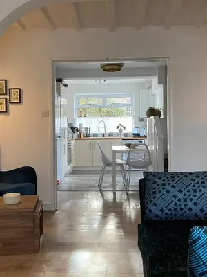 a living room and kitchen with a table and chairs at Comfy and Connected Standish Home - Two Mins from M6 Jct-27 in Standish
