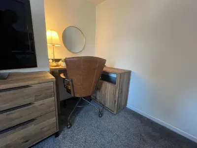 a room with a desk with a chair and a mirror at Comfy and Connected Standish Home - Two Mins from M6 Jct-27 in Standish